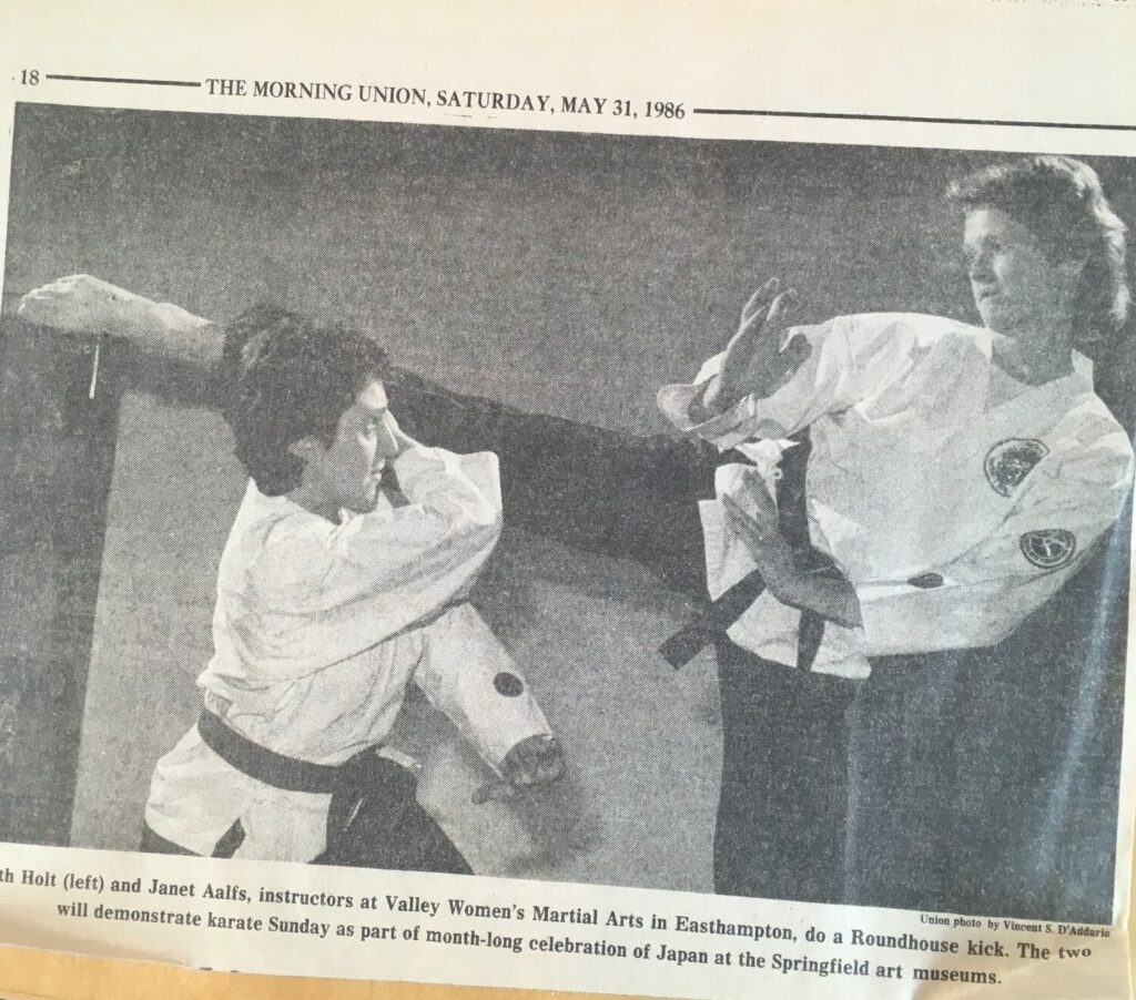 1986 newspaper clipping of Beth Holt and Janet Aalfs demonstrating karate roundhouse kick at Valley Women's Martial Arts Easthampton