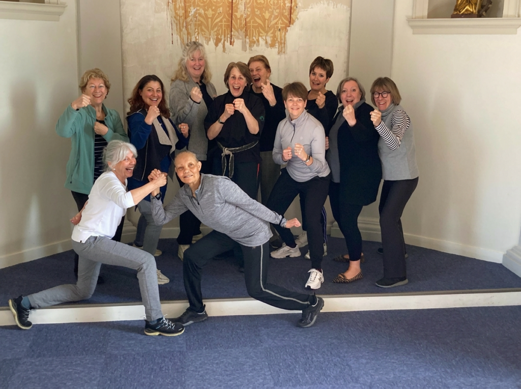 Diverse group of adults celebrating after self defense and empowerment workshop, Kawayan Martial Arts School Netherlands