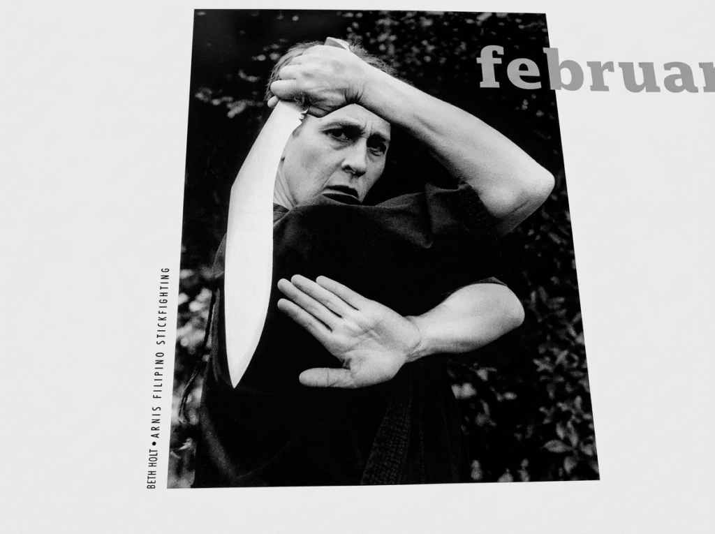 Beth Holt demonstrating Arnis Filipino stick fighting in archival black and white photograph, Kawayan Martial Arts School